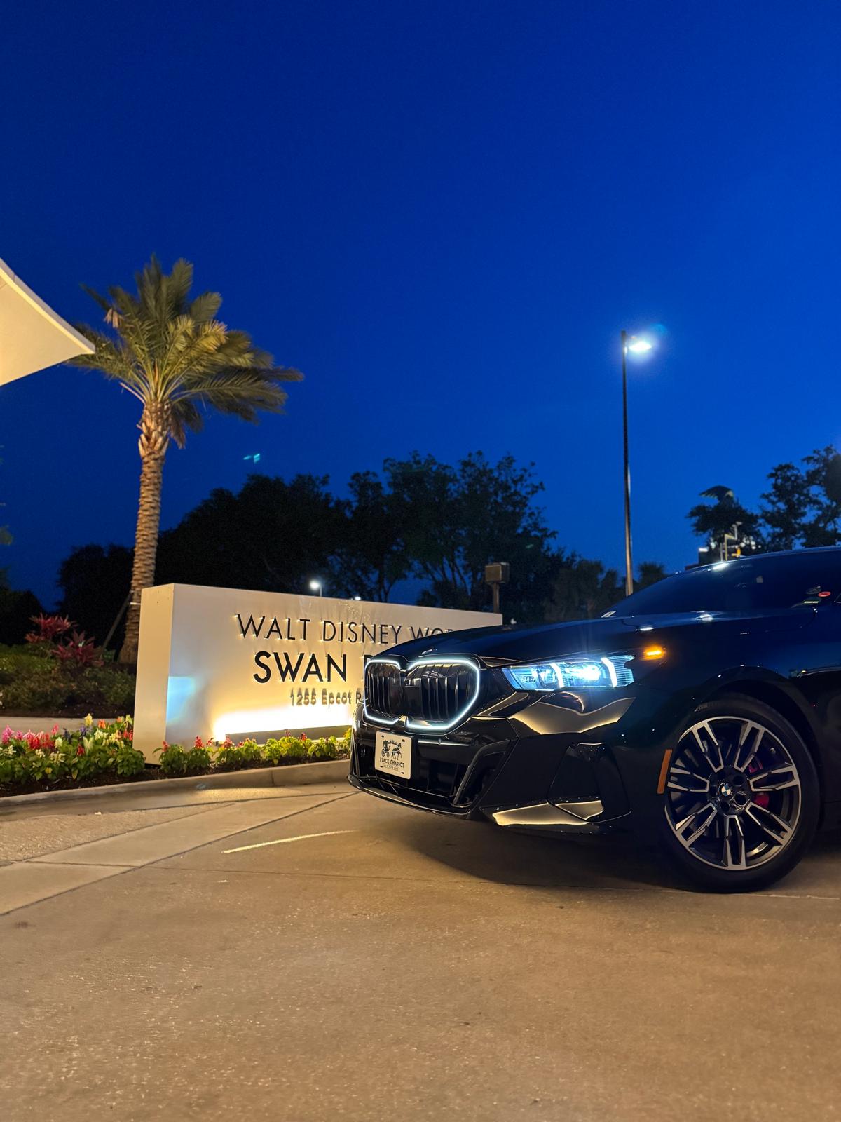 Black BMW luxury sedan at a Winter Park area resort in the evening