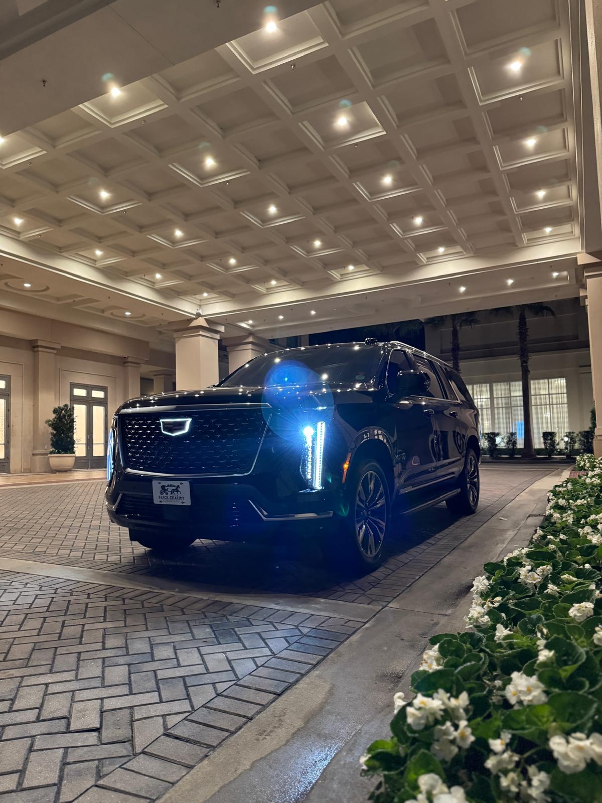 Black Cadillac Escalade under an elegant resort porte-cochere for an Orlando wedding